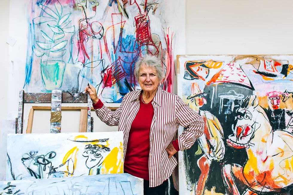 Piera McArthur in her studio with her paintings